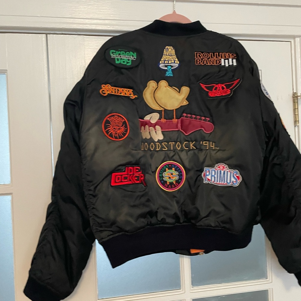 Woodstock 94 bundle. Jacket, sack, zippo, program, coin, button, & frisbee.